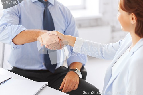 Image of business people shaking hands in office