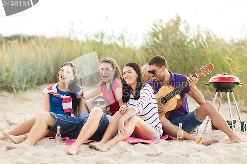 Image of group of friends having fun on the beach
