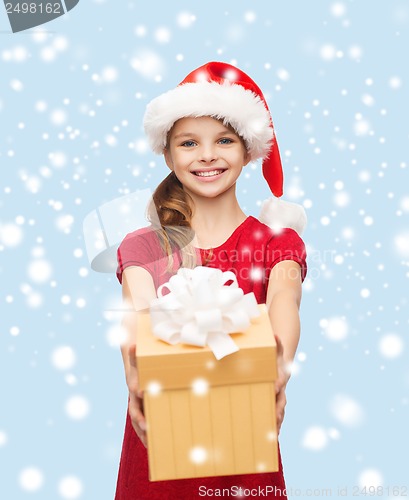 Image of smiling girl in santa helper hat with gift box