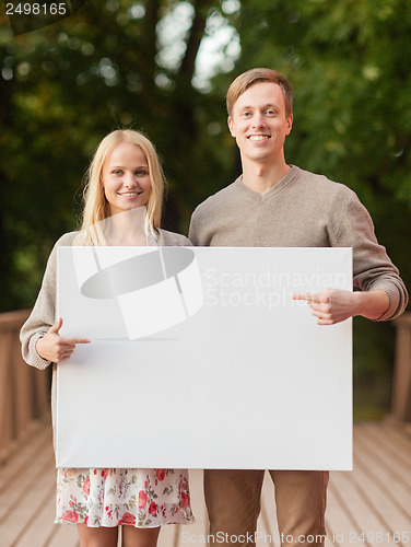 Image of romantic couple with blank white board