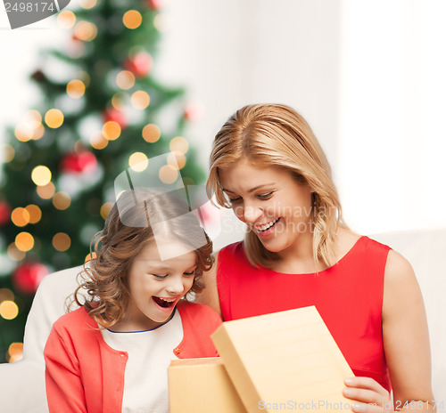 Image of happy mother and child girl with gift box