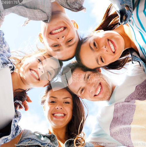 Image of group of teenagers looking down