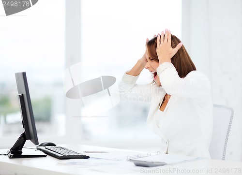 Image of stressed woman with computer