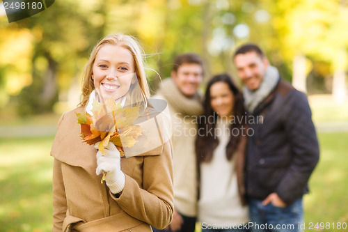 Image of group of friends having fun in autumn park