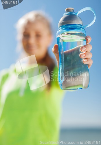 Image of woman showing a bottle of water