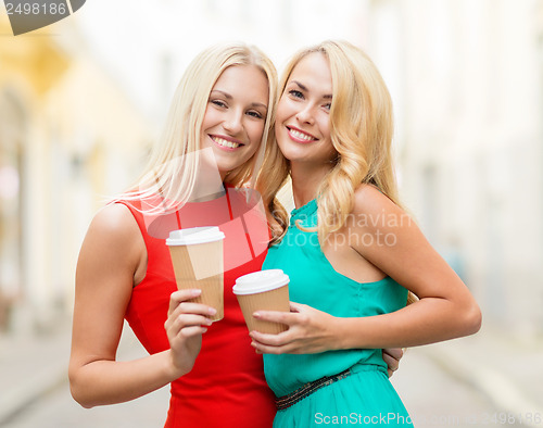 Image of women with takeaway coffee cups in the city