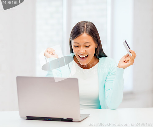 Image of businesswoman with laptop and credit card