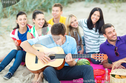 Image of group of friends having fun on the beach