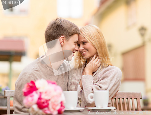 Image of romantic happy couple kissing in the cafe