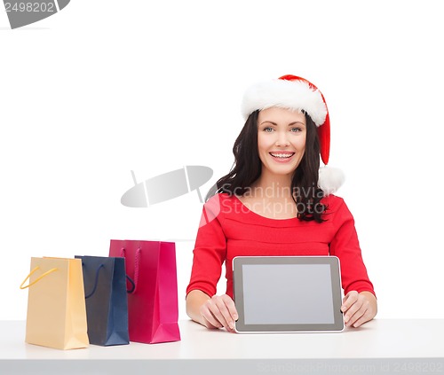 Image of woman in santa helper hat with tablet pc