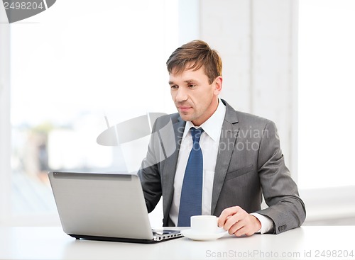 Image of businessman working with laptop computer