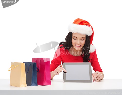 Image of woman in santa helper hat with tablet pc