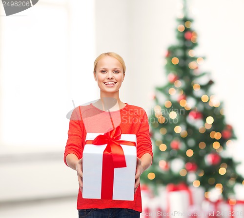 Image of smiling woman in red sweater with gift box