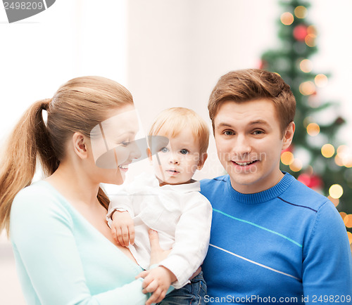 Image of happy parents playing with adorable baby