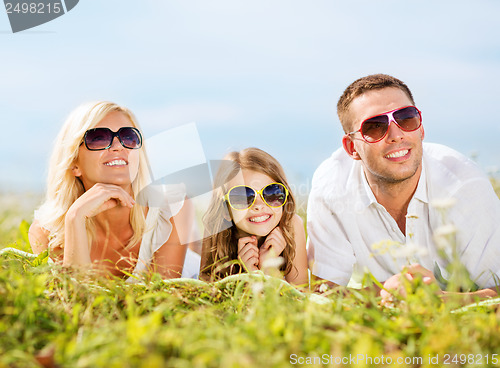 Image of happy family with blue sky and green grass