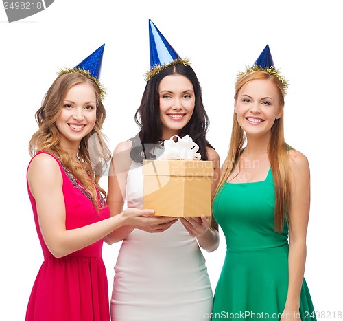 Image of three smiling women in blue hats with gift box