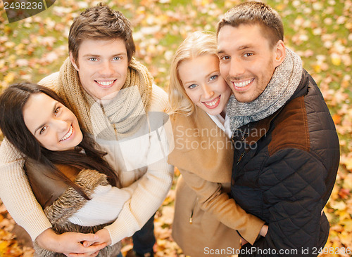 Image of group of friends having fun in autumn park