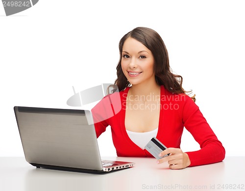 Image of happy woman with laptop computer and credit card