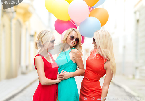 Image of beautiful girls with colorful balloons in the city