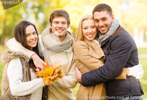 Image of group of friends having fun in autumn park