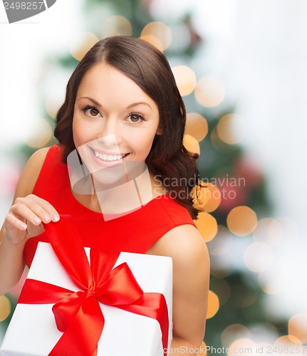 Image of smiling woman in red dress with gift box