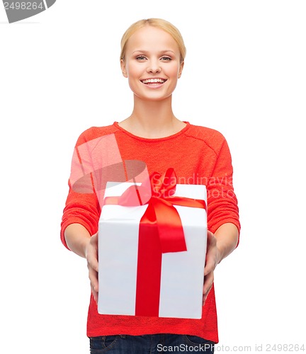 Image of smiling woman in red sweater with gift box