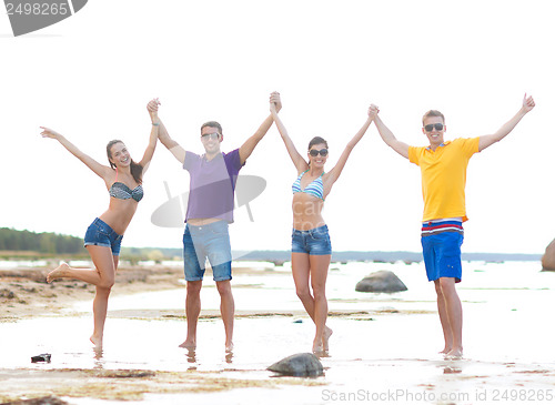 Image of group of friends having fun on the beach