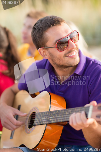 Image of group of friends having fun on the beach