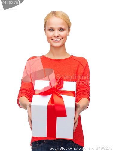 Image of smiling woman in red sweater with gift box