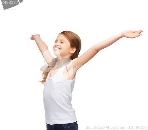 Image of smiling teenage girl with raised hands