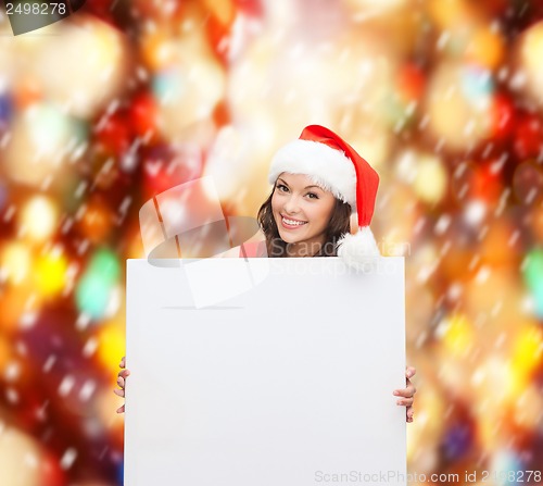 Image of woman in santa helper hat with blank white board