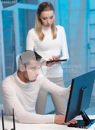 Image of woman and man with computer in the lab