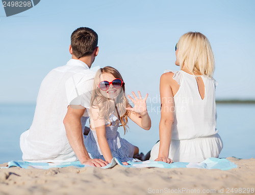 Image of happy family on the beach