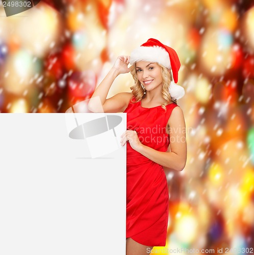 Image of woman in santa helper hat with blank white board