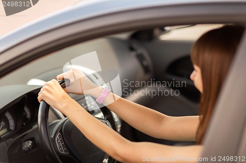 Image of happy woman driving a car