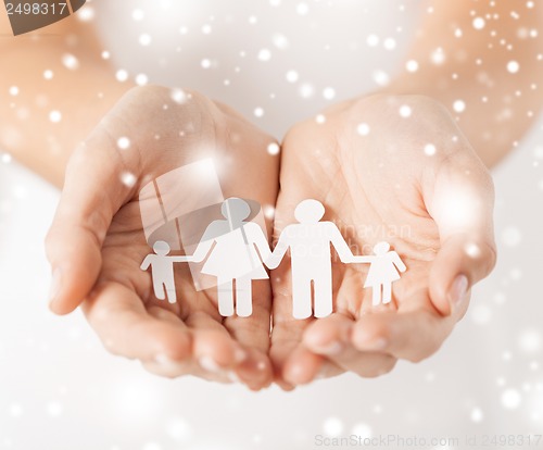 Image of woman hands with paper man family