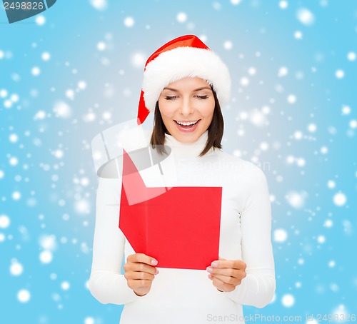 Image of woman in santa helper hat with blank red postcard