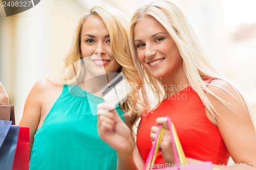 Image of beautiful women with shopping bags in the ctiy