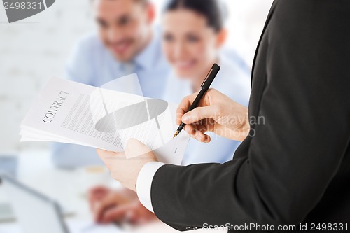 Image of man signing contract