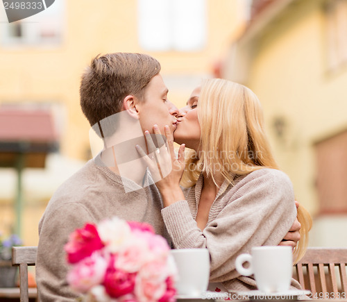 Image of romantic happy couple kissing in the cafe