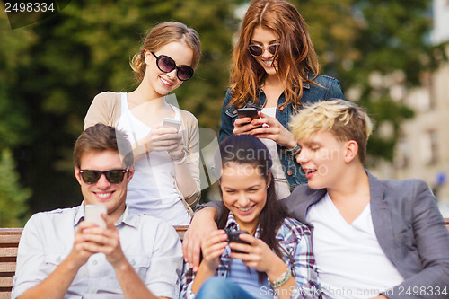 Image of students looking at smartphones and tablet pc
