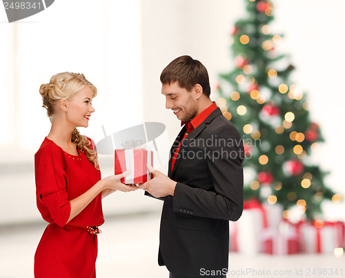 Image of smiling woman and man with gift box