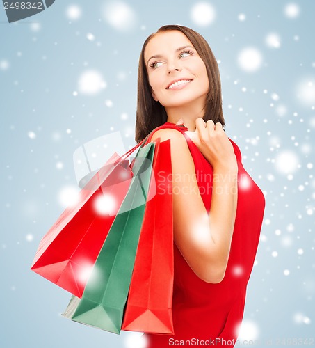 Image of woman in red dress with shopping bags