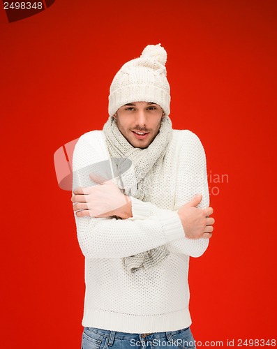Image of man in warm sweater, hat and scarf