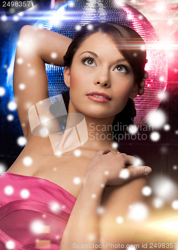 Image of woman in evening dress wearing diamond earrings