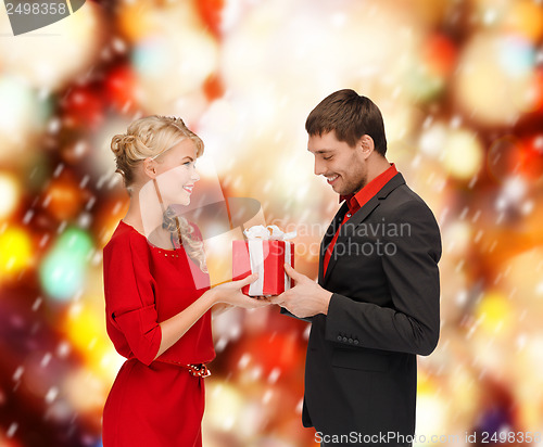 Image of smiling woman and man with gift box