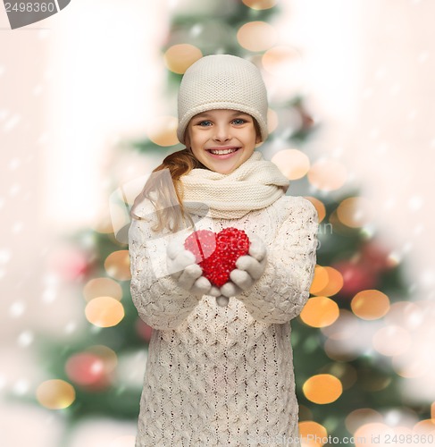 Image of girl in winter clothes with small red heart