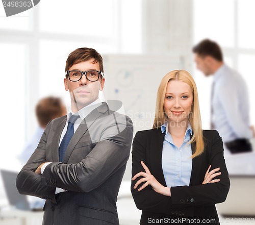 Image of businessman and businesswoman in the front of team