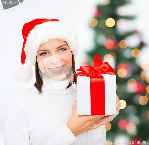 Image of smiling woman in santa helper hat with gift box