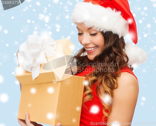 Image of smiling woman in santa helper hat with gift box